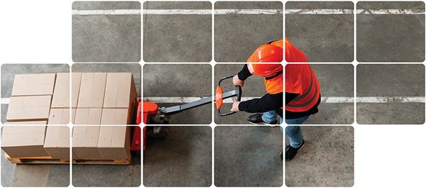 Staff member towing manual hoist with boxes